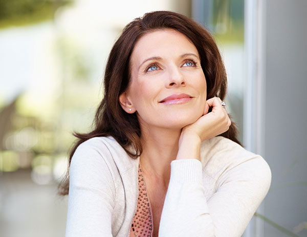 Women at a table looking thoughtfully upwards