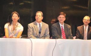 Dr. Ma with others at a table at Handel Reynolds Memorial Lecture in 2013