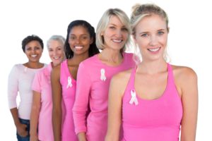 Image of women in single file looking at camera and smiling